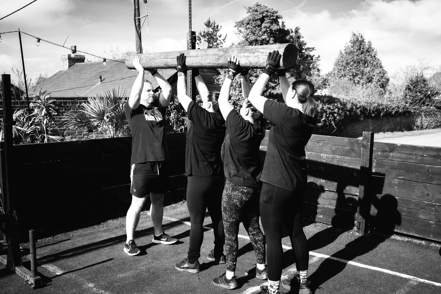MiBootcamp members carrying a log together at Pratt's Farm